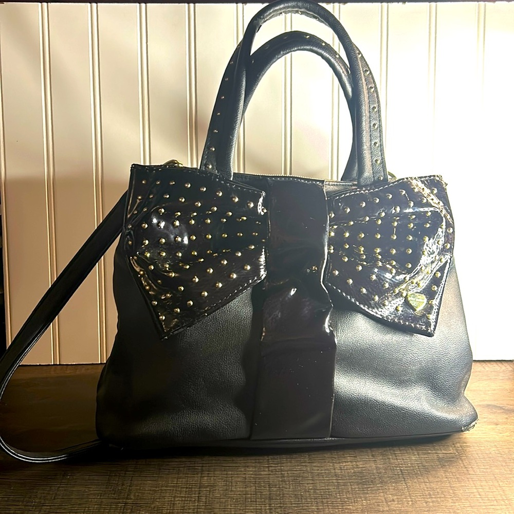 Betsey Johnson bag is beautiful and unique. Very gently used